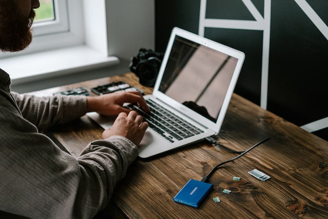 man trying to power cycle a laptop