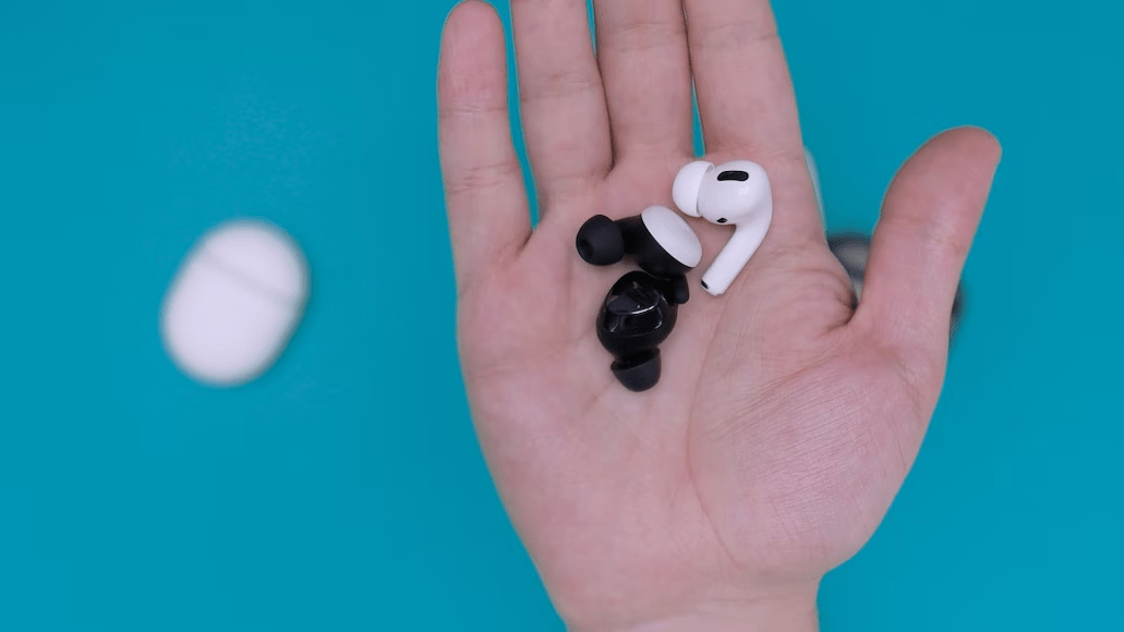 hand holding a bunch of AirPods