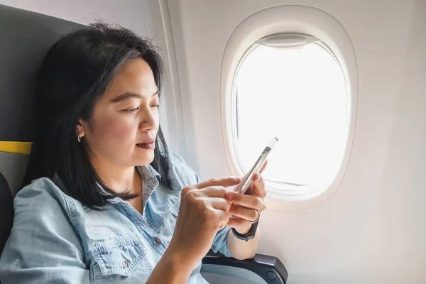 woman using phone in the plane